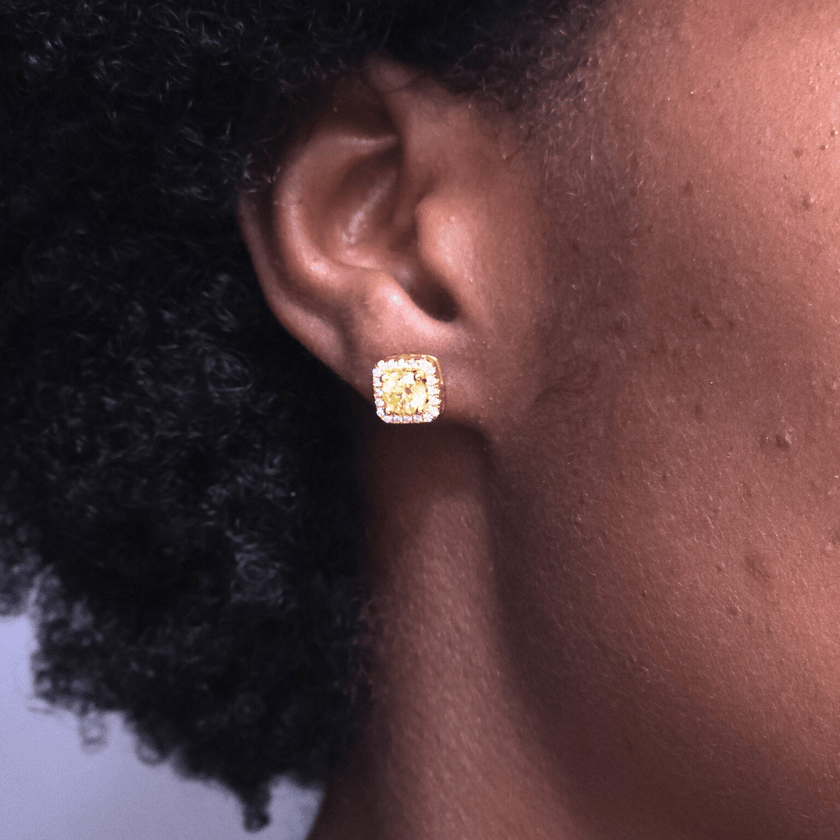 close up of girl wearing square shaped golden yellow colored moissanite stud earrings
