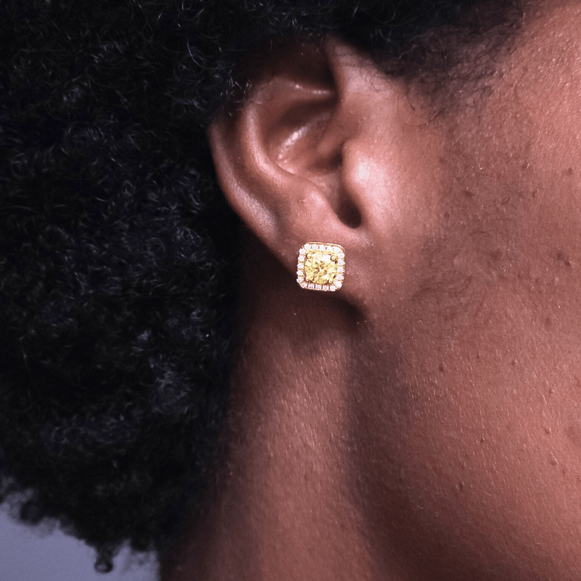 close up of girl wearing square shaped golden yellow colored moissanite stud earrings