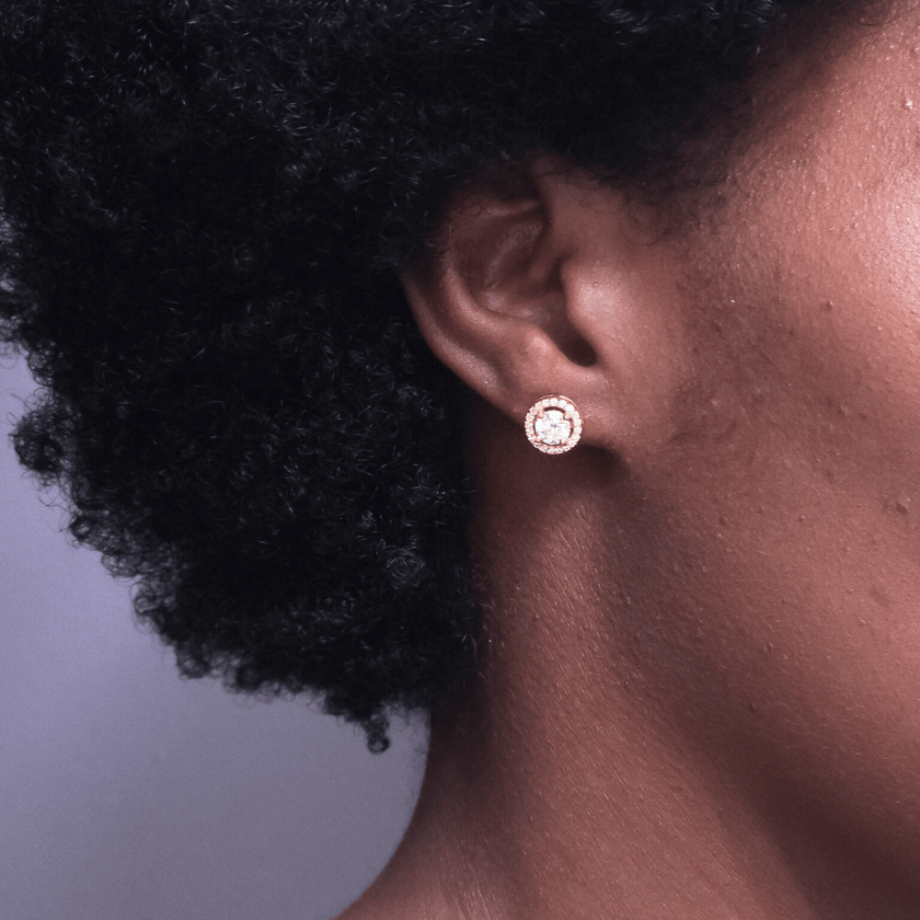 girl wearing moissanite stud earrings made with 18 karat gold plated stainless steel