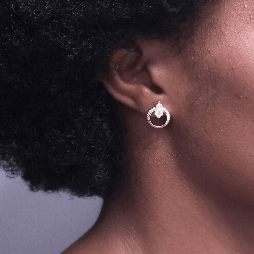 girl wearing sparking 14 karat gold plated sterling silver stud earring featuring marquise stones and crystal halos