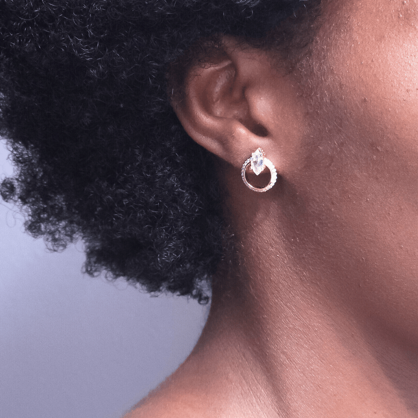 sparkling 14 karat gold plated sterling silver stud earring featuring marquise stones and crystal halos