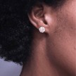 close up of girl wearing jack and jill of America inspired pink and blue crystal earrings featuring a halo design made with 18 karat gold plated sterling silver