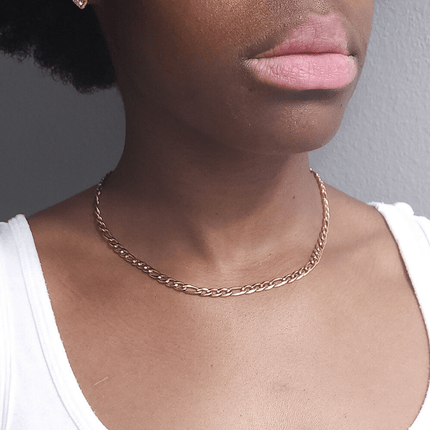 girl wearing stainless steel 18 karat gold plated figaro chain necklace