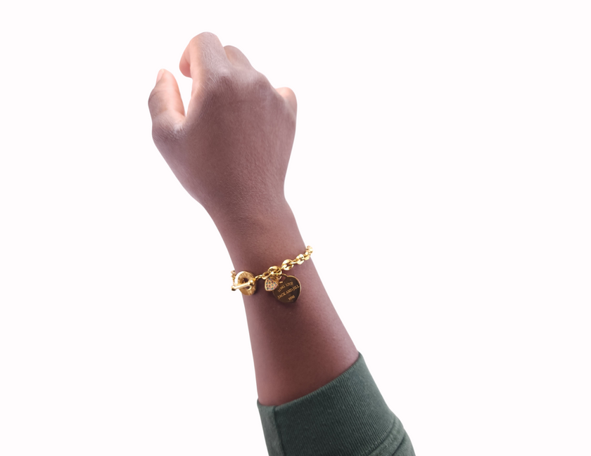 Wearing Jack and jill of America inspired toggle charm bracelet made of 18 karat gold plated stainless steel containing long live jack and jill quote