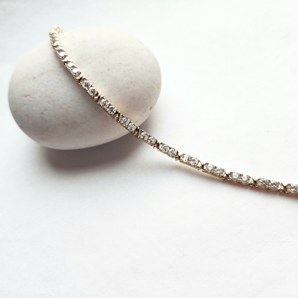 Diamond bracelet on a white stone with a white background