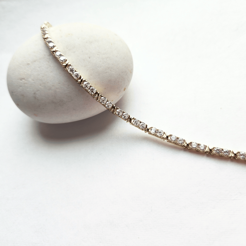 Diamond bracelet on a white stone with a white background